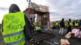 Gilets jaunes protesters block the road leading to the Frontignan oil depot in the south of France on 3 December 2018